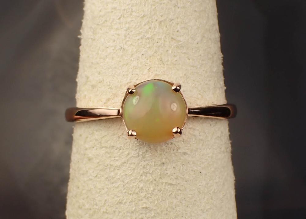 Appraisal: OPAL AND FOURTEEN KARAT GOLD SOLITAIRE RING The rose gold