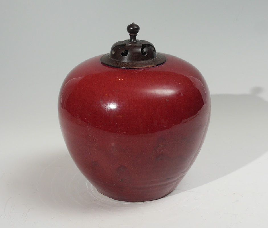 Appraisal: CHINESE OXBLOOD COVERED JAR Bulbous oxblood glaze jar carved wood