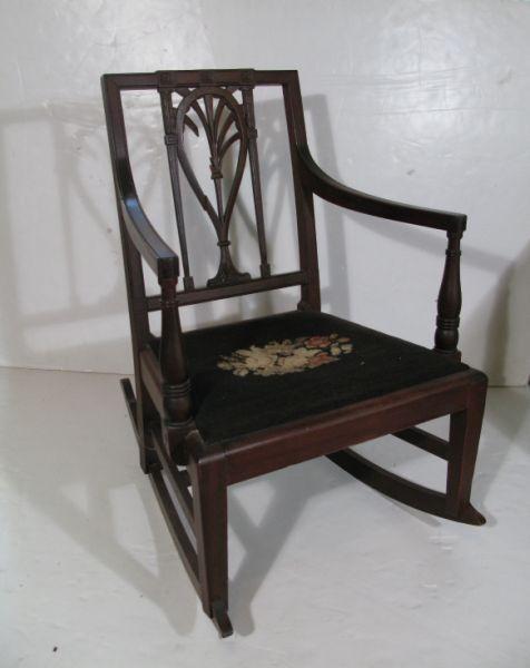 Appraisal: Neoclassical Style Rocking Chair mahogany frame with needlepoint seat In