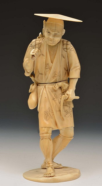 Appraisal: A JAPANESE IVORY SECTIONAL FIGURE OF A FARMER carrying a