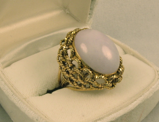 Appraisal: WHITE JADE AND FOURTEEN KARAT GOLD RING set with a