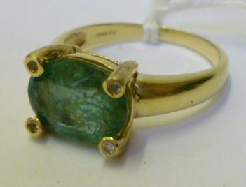 Appraisal: AN EMERALD DRESS RING the horizontal set faceted emerald claw