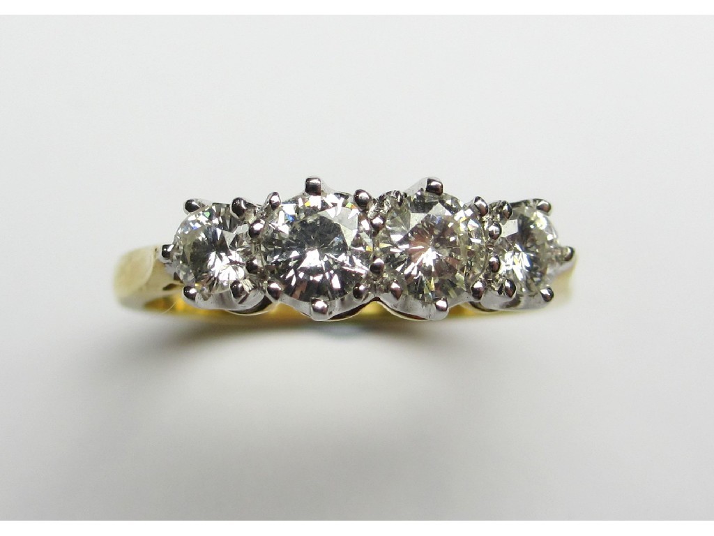 Appraisal: An eighteen carat gold diamond four stone ring with brilliant