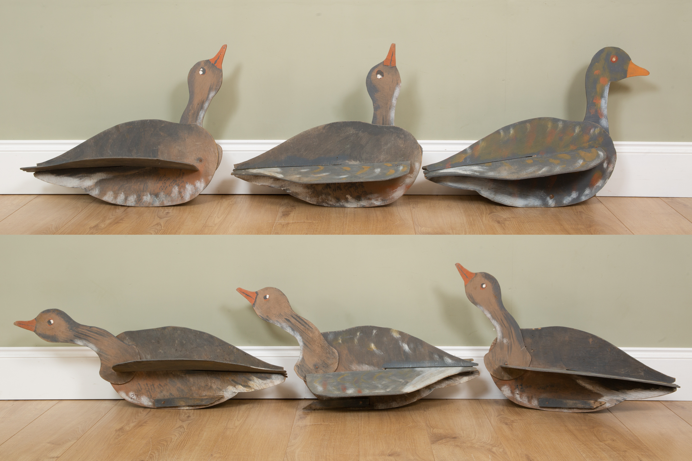 Appraisal: A collection of five painted plywood decoy geese with adjustable