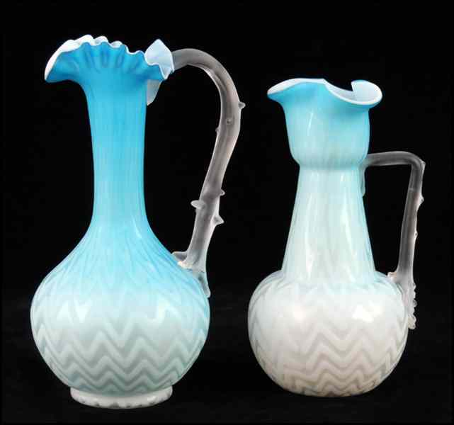 Appraisal: TWO BLUE ZIG-ZAG SATIN GLASS CLARET JUGS Both with ruffled