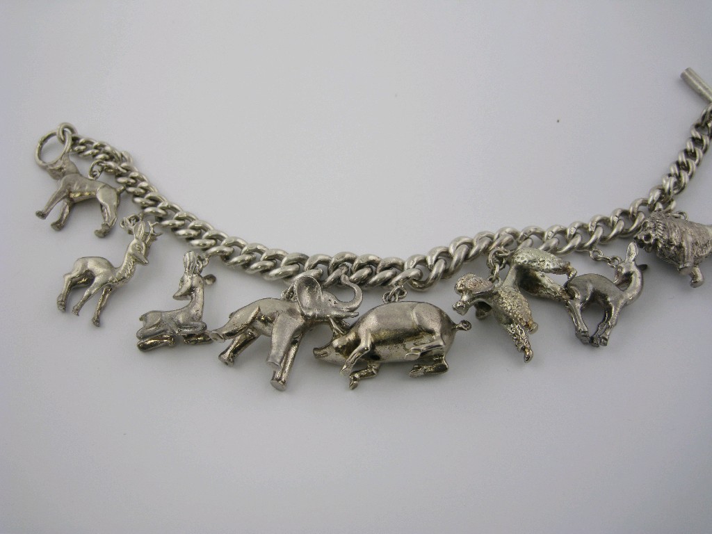 Appraisal: A silver curb-link Bracelet with T bar clasp and eight