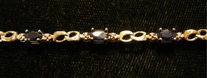 Appraisal: karat white gold sapphire and diamond flexible braceletTen petite Oval