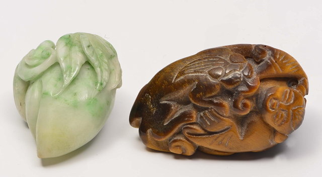 Appraisal: A CHINESE WHITE AND GREEN JADE PEBBLE carved as a