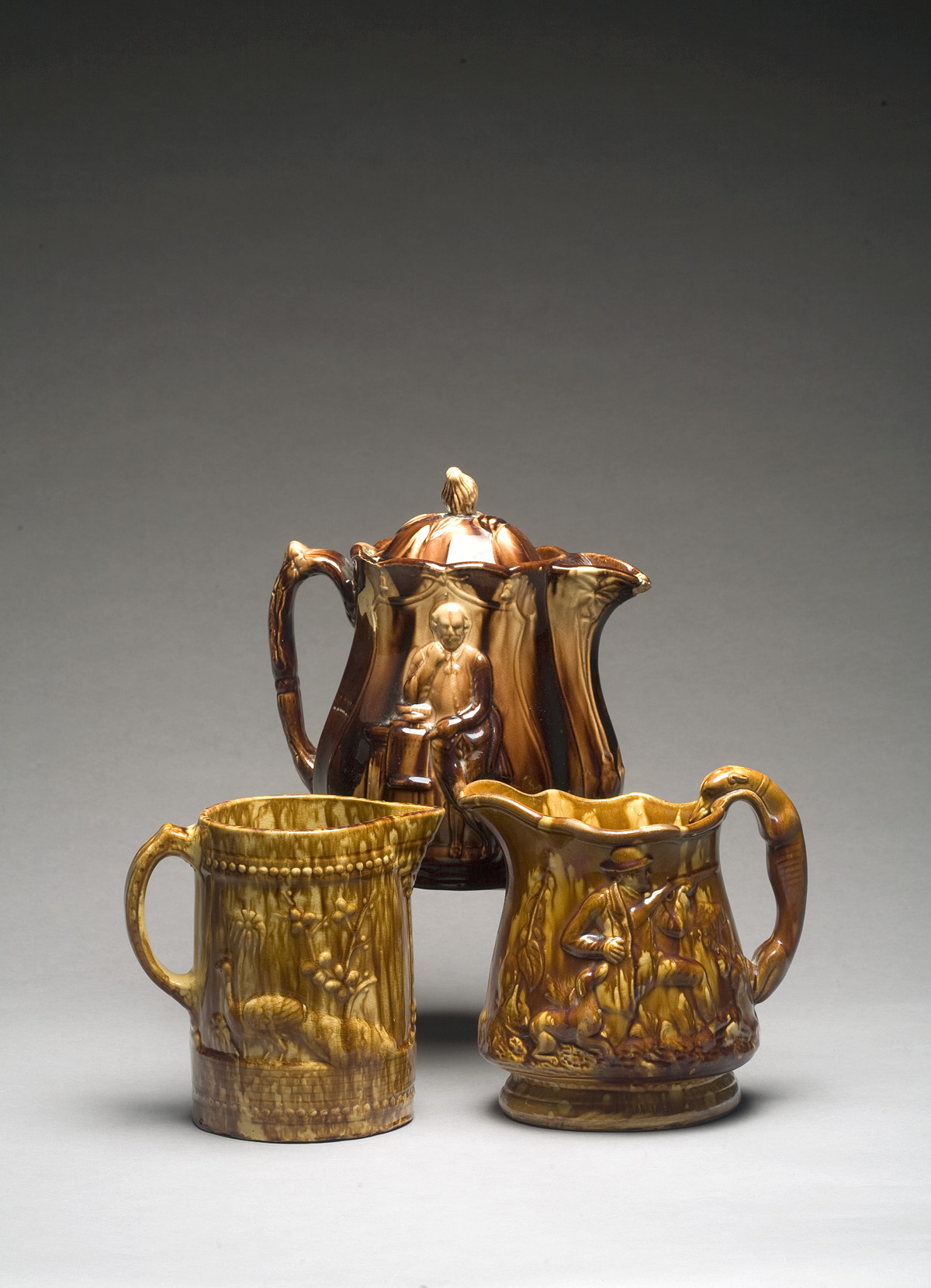 Appraisal: AMERICAN ROCKINGHAM-GLAZED 'SHAKESPEARE' PATTERN PITCHER AND COVER NINETEENTH CENTURY Together