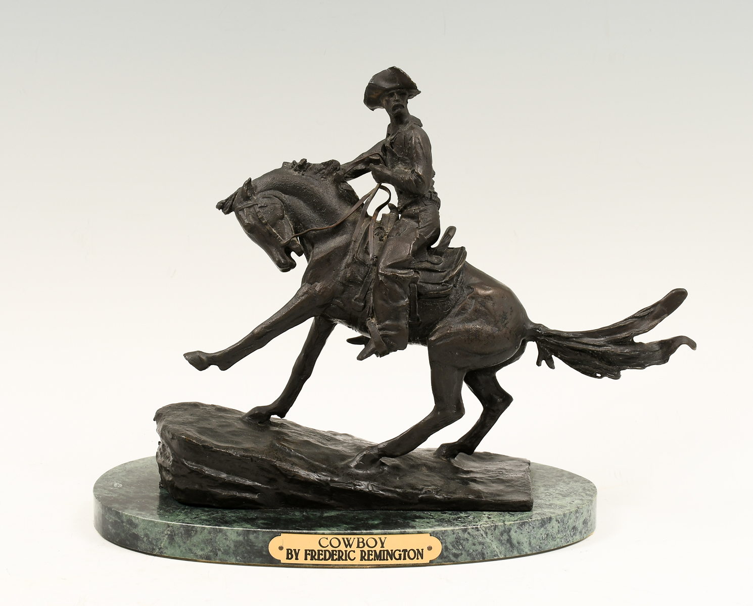 Appraisal: COWBOY BRONZE AFTER FREDERIC REMINGTON Approximately '' in height with