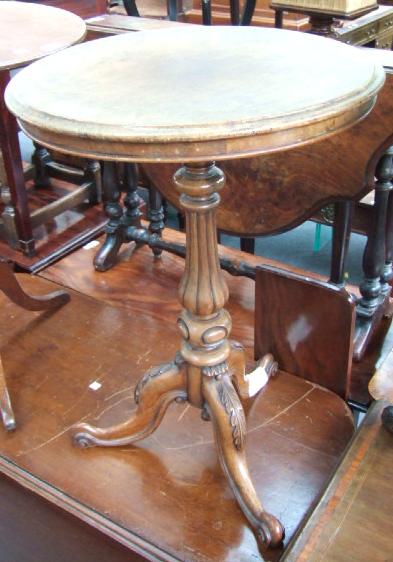 Appraisal: A Victorian walnut occasional table the circular top on a