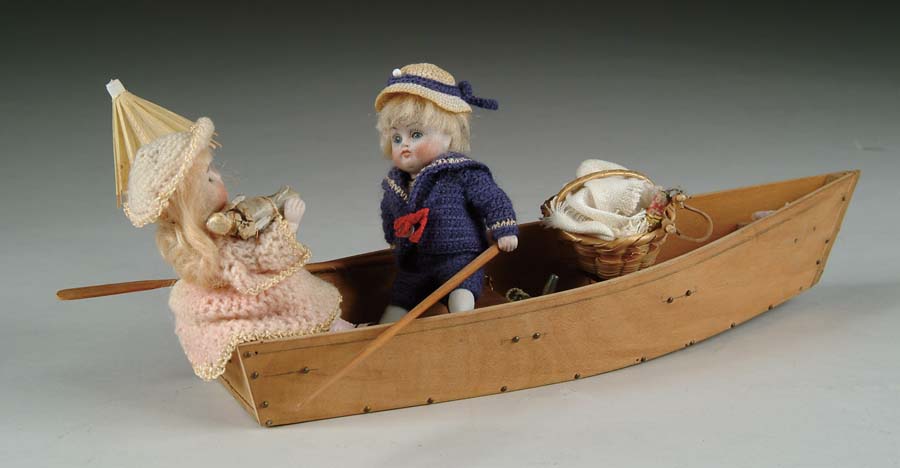 Appraisal: PAIR OF JOINTED ALL-BISQUE BOY AND GIRL IN ROWBOAT A