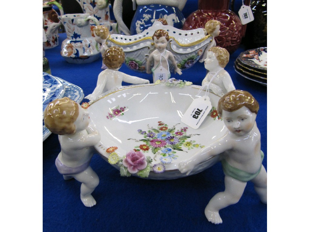 Appraisal: Two Scherholz porcelain bowls each held aloft by four Putti