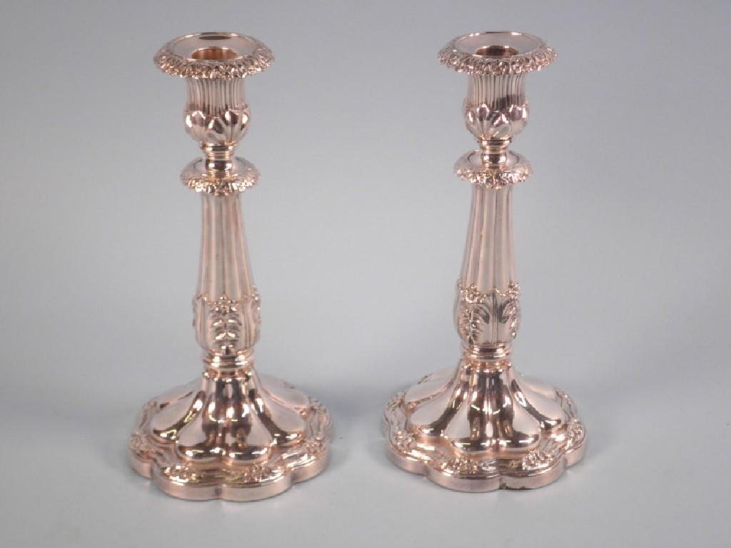 Appraisal: A pair of silver plated candlesticks each cast with leaves