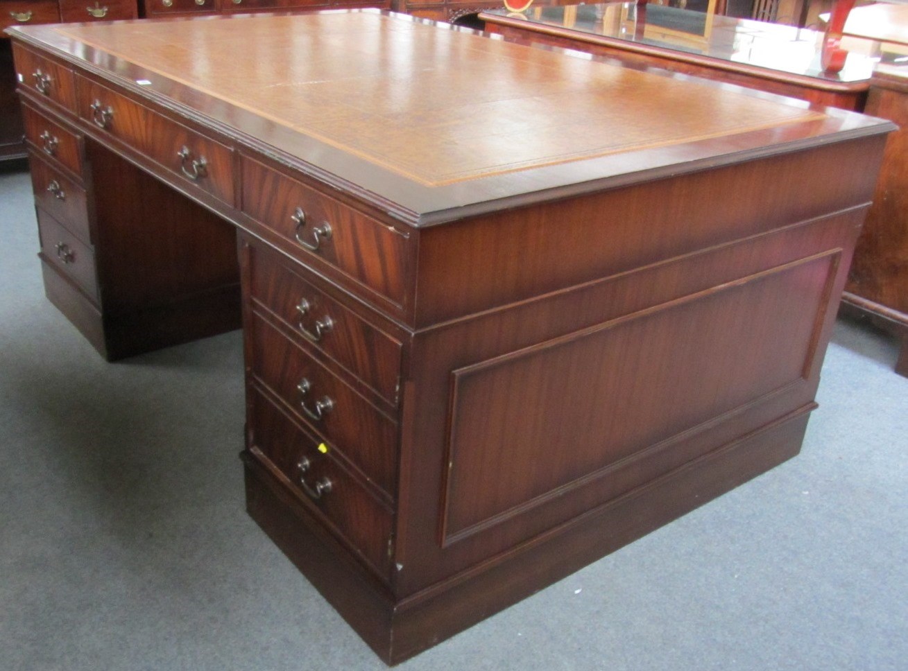 Appraisal: A George III style mahogany partners desk with nine drawers