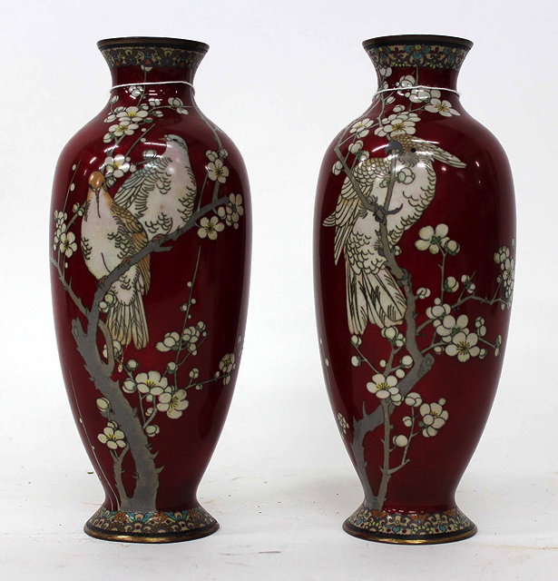 Appraisal: A PAIR OF ORIENTAL RED GROUND CLOISONNE VASES one decorated