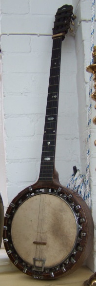 Appraisal: A rosewood framed banjo with applied brass plaque detailed 'The