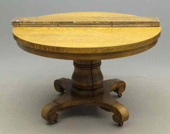 Appraisal: th c round oak dining table with leaves Top ''