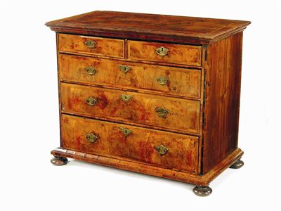 Appraisal: A walnut chest the later quarter veneered top with feather