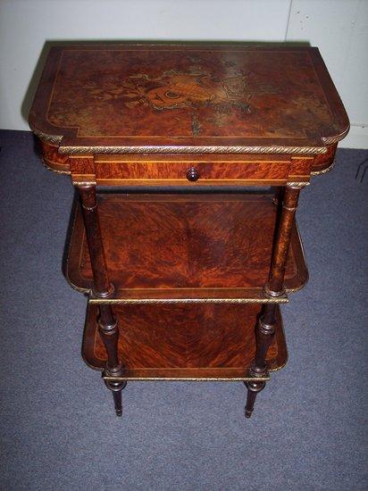 Appraisal: A burr yew three tier-etagere with brass mounted border the