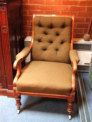 Appraisal: A TH CENTURY OAK OPEN ARMCHAIR with upholstered back arms