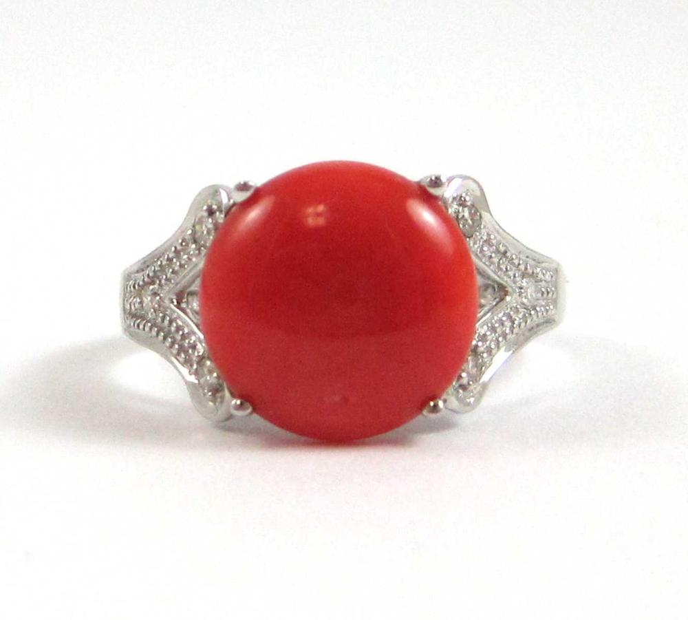 Appraisal: CORAL DIAMOND AND FOURTEEN KARAT WHITE GOLD RING with three