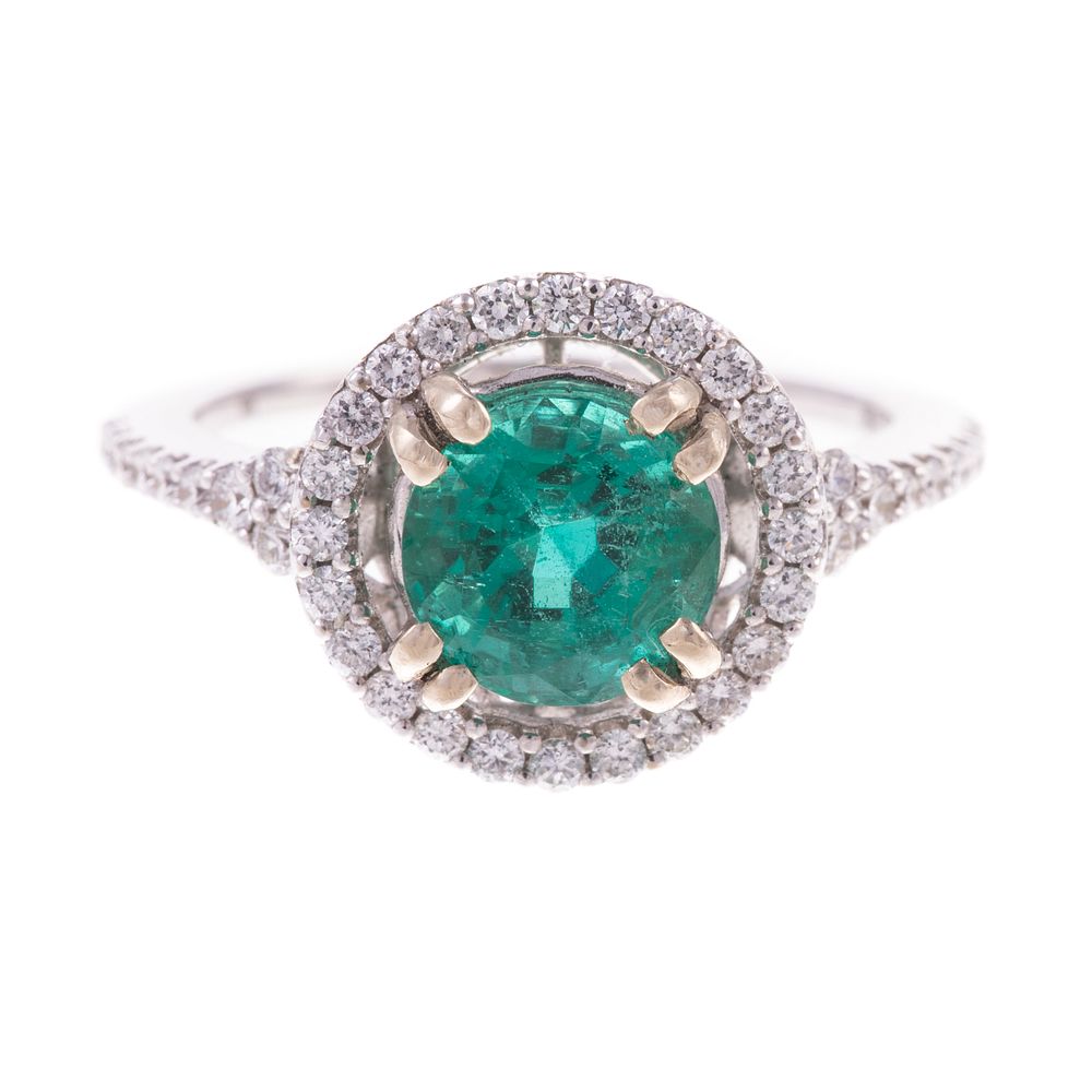 Appraisal: An Emerald and Diamond Halo Ring in K K white