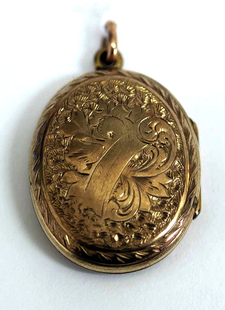 Appraisal: A YELLOW METAL AND BLACK ENAMEL DECORATED MEMORIAL OVAL LOCKET