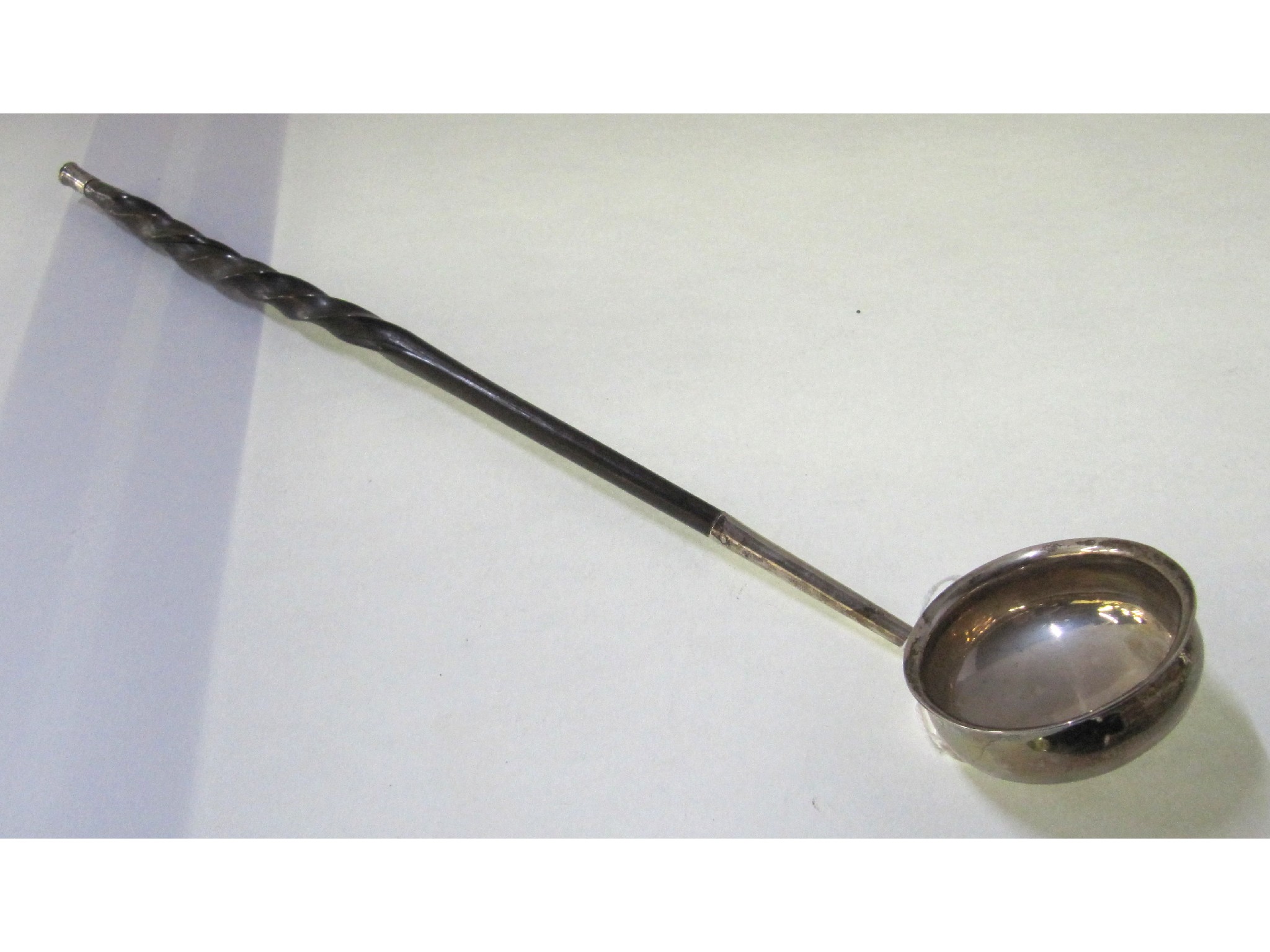 Appraisal: A George III silver bowled toddy ladle with spiral handle