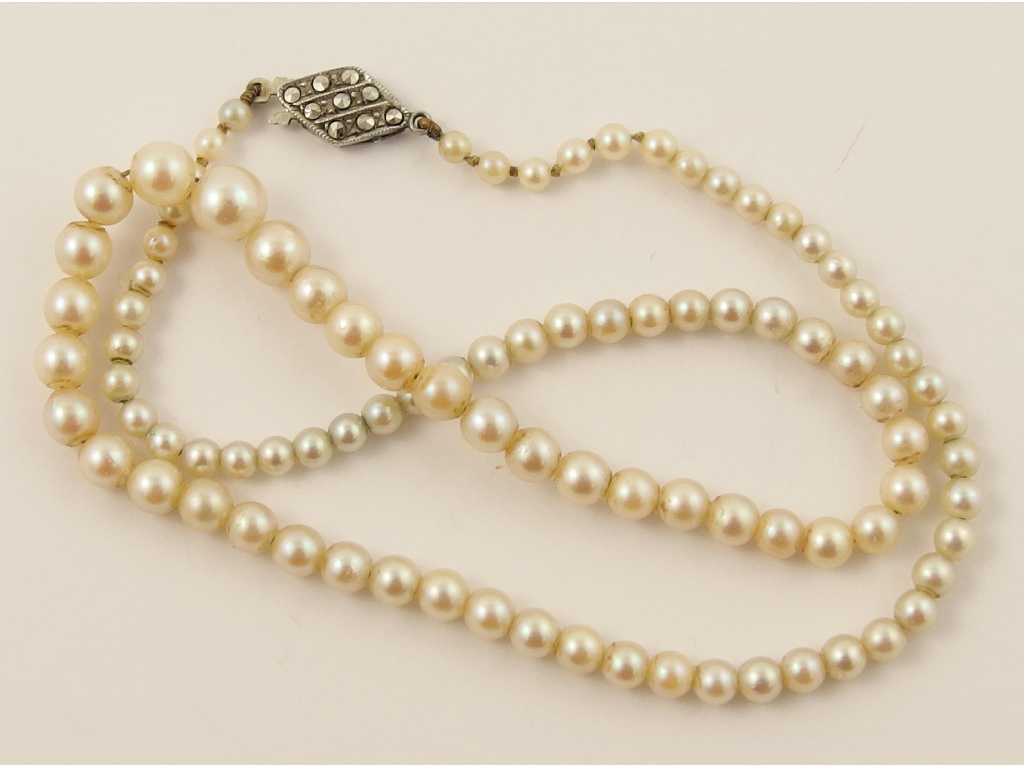 Appraisal: A string of cultured pearls with a silver clasp