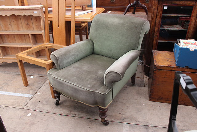 Appraisal: A VICTORIAN GREEN UPHOLSTERED ARMCHAIR with turned tapering front legs