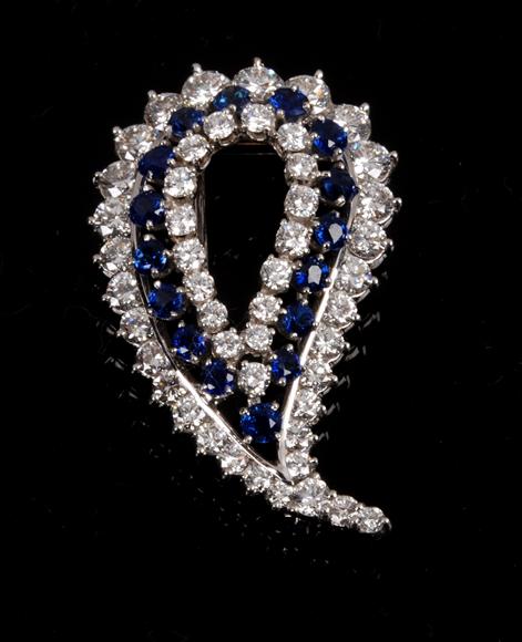 Appraisal: A sapphire and diamond brooch designed as a stylised leaf