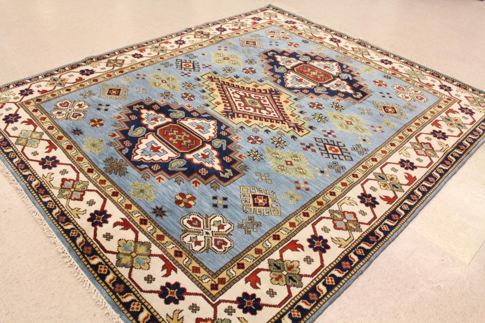 Appraisal: HAND KNOTTED ORIENTAL CARPET Indo-Caucasian three geometric medallions and other