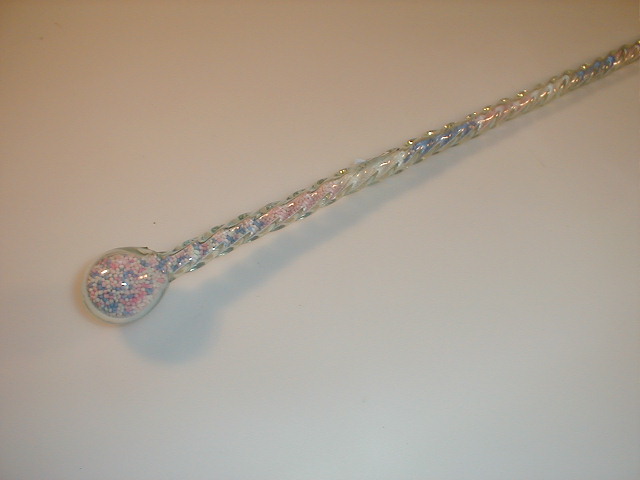 Appraisal: A thC twist glass cane frigger filled with coloured beads