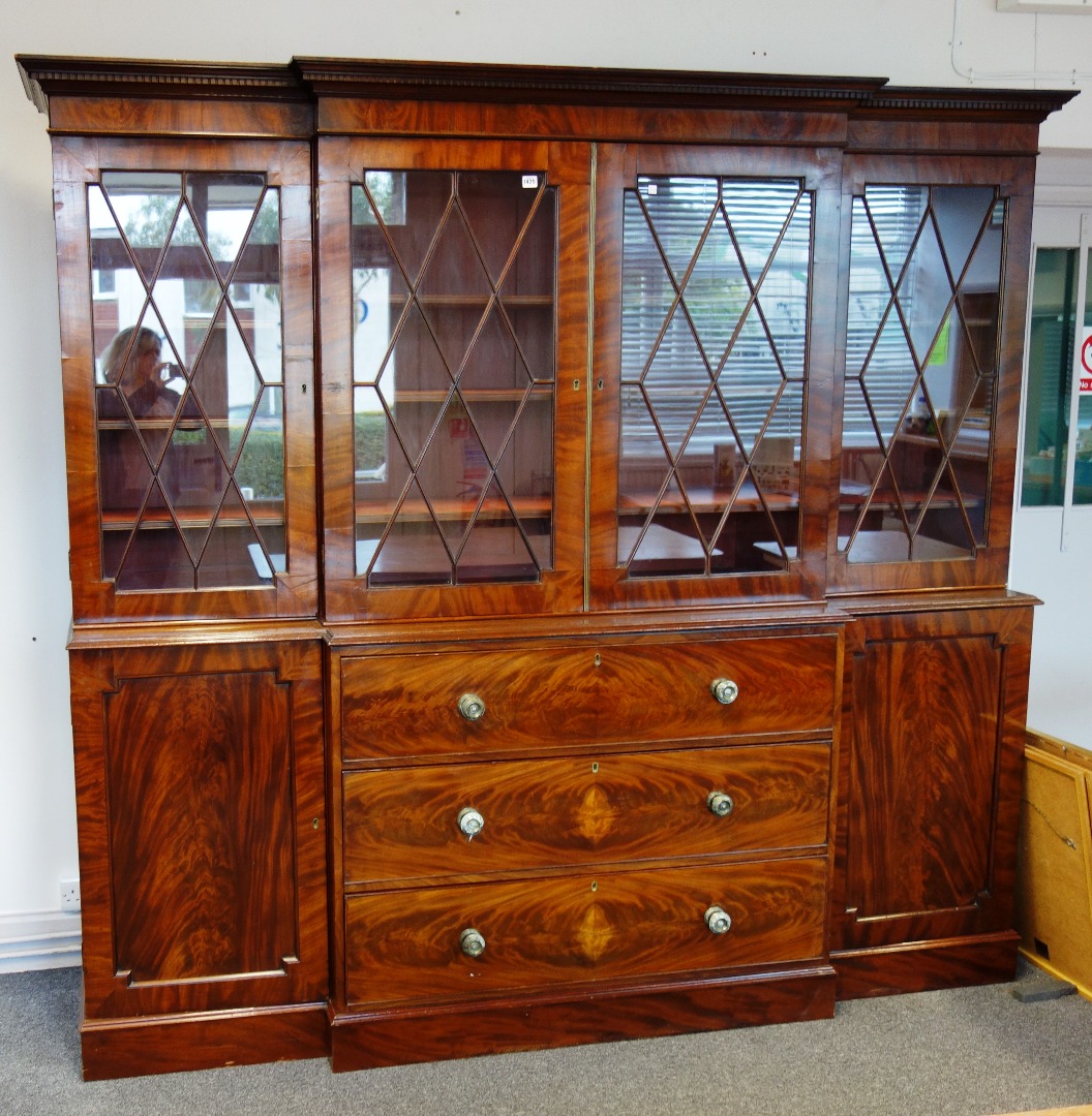 Appraisal: A th century mahogany breakfront secretaire bookcase cabinet the dentil