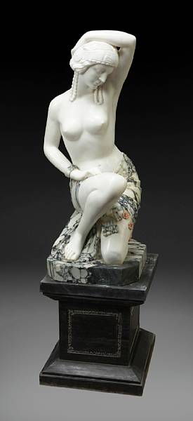 Appraisal: An Art Deco style carved marble figure The kneeling semi-nude