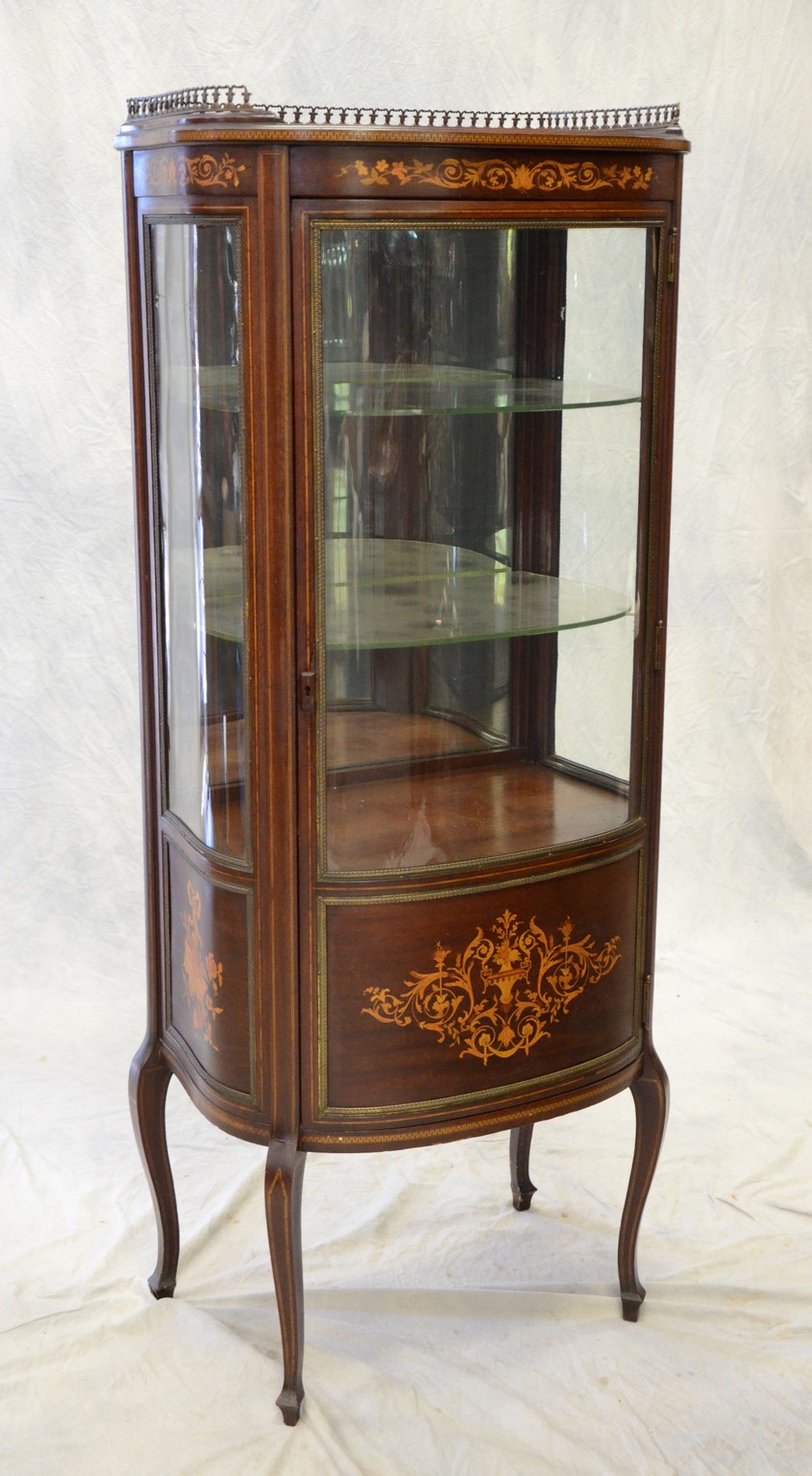 Appraisal: Inlaid mahogany bowed glass French style curio cabinet with pierced