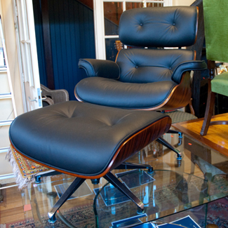 Appraisal: BLACK EAMES STYLE LOUNGE CHAIR WITH MATCHING FOOT STOOL