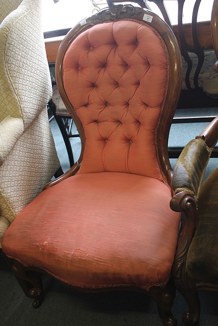 Appraisal: A VICTORIAN WALNUT FRAMED SPOON BACK NURSING CHAIR with scroll