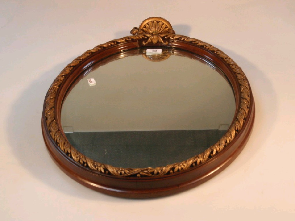 Appraisal: An thC style oval wall mirror in mahogany and gilt