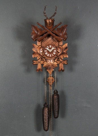 Appraisal: German Black Forest style cuckoo clock with metal pine cone