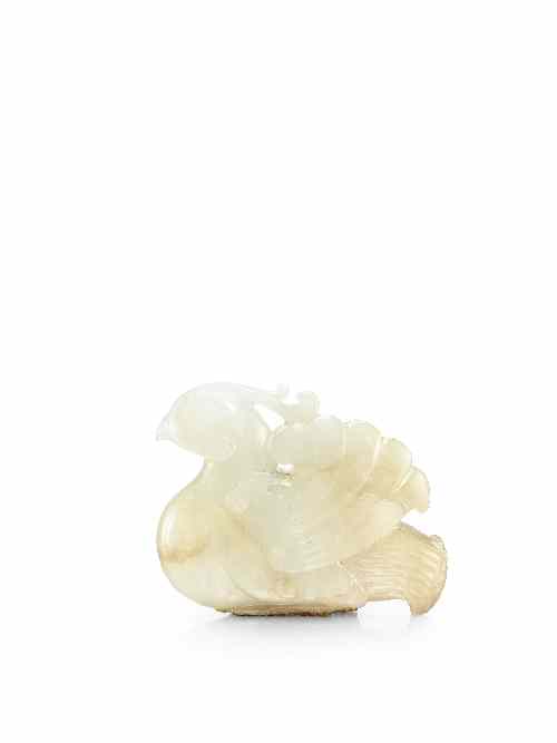 Appraisal: A Chinese celadon jade carving of a recumbent phoenix the