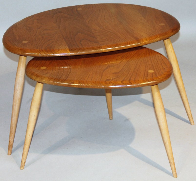 Appraisal: A nest of two Ercol lightwood occasional tables with shaped