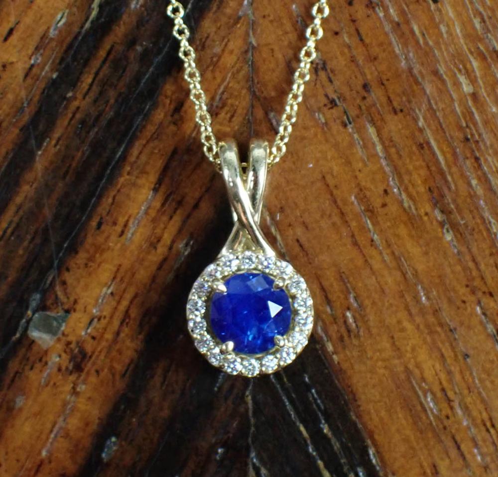 Appraisal: SAPPHIRE DIAMOND AND FOURTEEN KARAT GOLD PENDANT NECKLACE with an