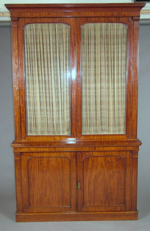 Appraisal: A Victorian mahogany bookcase cabinet the cavetto cornice over twin