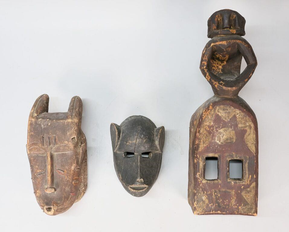 Appraisal: wood carved masks in the style of the Dogon and