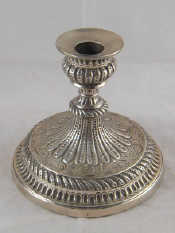 Appraisal: A short but impressive embossed Georgian silver candlestick on a