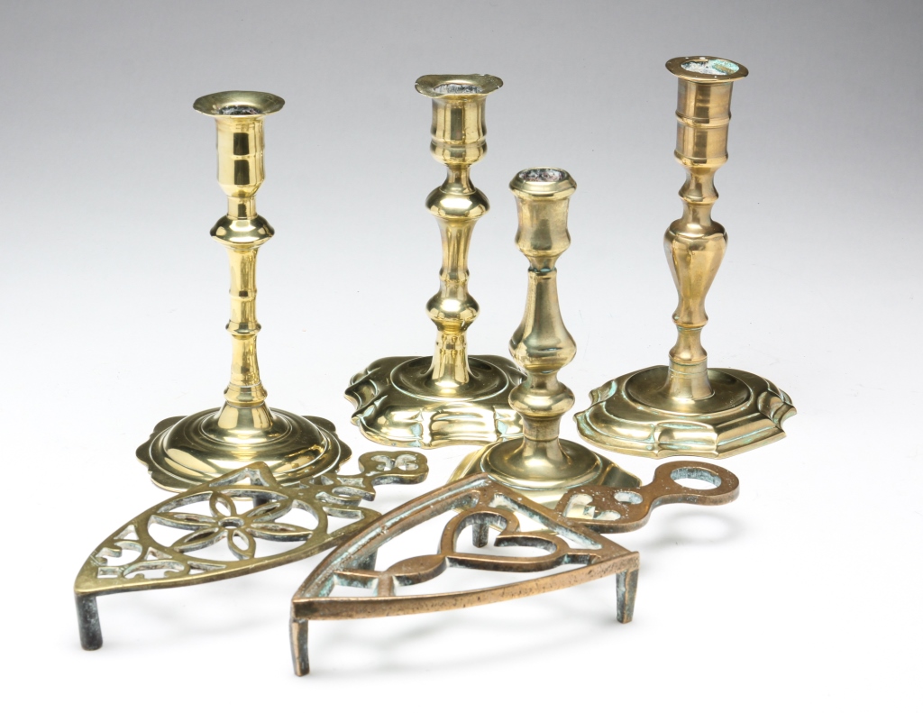 Appraisal: FOUR ENGLISH BRASS CANDLESTICKS AND TWO TRIVETS Mid th- th