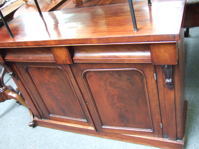 Appraisal: A Victorian mahogany chiffonier with a pair of cushion frieze