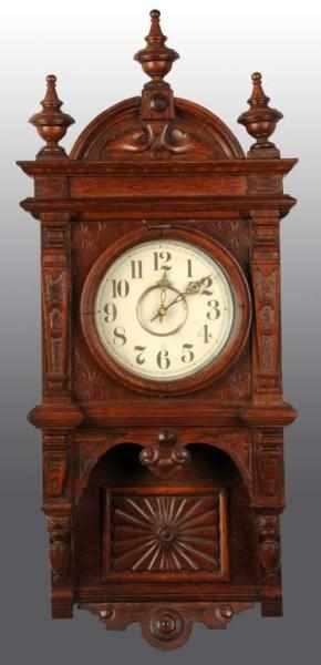 Appraisal: Oak Wall Clock Description Has open pendulum and two weights